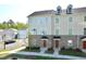 Beautiful three-story townhome featuring a brick and siding exterior with large windows at 1020 Kentlands Dr, Durham, NC 27713