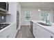 Modern kitchen features stainless steel appliances, gas cooktop, and an island with a sink at 1020 Kentlands Dr, Durham, NC 27713