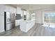 Bright kitchen features stainless steel appliances, white cabinets, and a large center island with a sink at 1020 Kentlands Dr, Durham, NC 27713