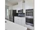Bright kitchen features stainless steel appliances, white cabinets, and a view into the home at 1020 Kentlands Dr, Durham, NC 27713