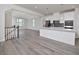 Open living space features hardwood floors, kitchen and view into the living room at 1020 Kentlands Dr, Durham, NC 27713