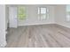 Living room features hardwood floors, natural light from windows, and white walls at 1020 Kentlands Dr, Durham, NC 27713