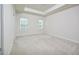 Spacious main bedroom with a tray ceiling and large windows at 1020 Kentlands Dr, Durham, NC 27713