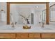 Elegant bathroom featuring double sinks, wood cabinets, and a decorative mirror at 103 Temple Gate Dr, Cary, NC 27518
