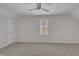 A bright bedroom with neutral colored walls, carpet floors, and a ceiling fan at 103 Temple Gate Dr, Cary, NC 27518