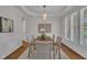 Formal dining room with wainscoting, decorative chandelier, and hardwood floors at 103 Temple Gate Dr, Cary, NC 27518