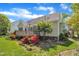 Rear exterior view of the home with a well-manicured lawn and blooming flowers at 103 Temple Gate Dr, Cary, NC 27518