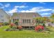 Exterior of the home with a deck, manicured lawn, garden, and mature trees at 103 Temple Gate Dr, Cary, NC 27518