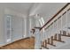Bright foyer featuring hardwood floors and staircase, leading to the upper level at 103 Temple Gate Dr, Cary, NC 27518