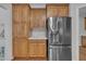 Stainless steel refrigerator with wood cabinets and quartz countertops at 103 Temple Gate Dr, Cary, NC 27518