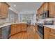 Bright kitchen with stainless steel appliances, wood cabinets, quartz countertops, and hardwood floors at 103 Temple Gate Dr, Cary, NC 27518