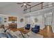 Open-concept living room with loft, hardwood floors, comfortable seating, and adjacent kitchen at 103 Temple Gate Dr, Cary, NC 27518