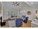 Inviting living room with large windows, fireplace, hardwood floors, and comfortable seating at 103 Temple Gate Dr, Cary, NC 27518