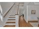 Elegant staircase with wood treads and white risers, flowing into hardwood flooring at 103 Temple Gate Dr, Cary, NC 27518