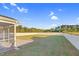 A large, well-maintained backyard featuring a white fence, a patio, and lush green grass at 105 Blooms Way, Kenly, NC 27542