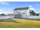 View of the backyard featuring an enclosed back porch, patio, and white fence at 105 Blooms Way, Kenly, NC 27542