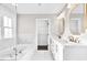 Luxurious bathroom with marble tile, double vanity, and separate tub and shower, ideal for relaxation at 105 Blooms Way, Kenly, NC 27542