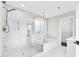 Bright bathroom features marble tile, glass shower and a soaking tub with gold hardware at 105 Blooms Way, Kenly, NC 27542