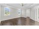 Large bedroom features hardwood floors, neutral paint, two windows, and access to ensuite bathroom at 105 Blooms Way, Kenly, NC 27542