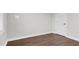Bright bedroom boasts hardwood floors, neutral paint, a white door, and ample natural light at 105 Blooms Way, Kenly, NC 27542
