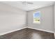 Bedroom features hardwood floors, neutral paint, a ceiling fan, and ample natural light at 105 Blooms Way, Kenly, NC 27542