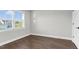 Bedroom features hardwood floors, neutral paint, a white door, and ample natural light at 105 Blooms Way, Kenly, NC 27542