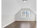 Bonus room features hardwood floors, neutral paint, a ceiling light, and ample natural light at 105 Blooms Way, Kenly, NC 27542