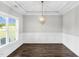 Formal dining room featuring hardwood floors, wainscoting, recessed lighting, and stylish chandelier at 105 Blooms Way, Kenly, NC 27542
