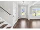 Bright foyer with hardwood floors, white trim and a transom window above the front door at 105 Blooms Way, Kenly, NC 27542