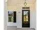 Exterior view of a black front door with glass panels, sidelight and white siding at 105 Blooms Way, Kenly, NC 27542