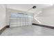 Spacious two-car garage with painted walls, brick base, and an automatic door opener at 105 Blooms Way, Kenly, NC 27542