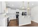 Modern kitchen features white cabinets, stainless steel appliances, and a stylish center island for dining at 105 Blooms Way, Kenly, NC 27542