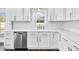 Bright kitchen with white cabinetry, stainless steel appliances, and a functional sink under the window at 105 Blooms Way, Kenly, NC 27542
