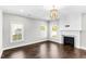 Living room with hardwood floors, fireplace, white trim, and plenty of natural light at 105 Blooms Way, Kenly, NC 27542