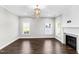 Bright living room with fireplace and elegant chandelier offers a cozy and stylish atmosphere at 105 Blooms Way, Kenly, NC 27542