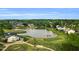 Beautiful aerial view of a community featuring a lake, golf course, and surrounding houses at 105 Ryder Cup Cir, Raleigh, NC 27603
