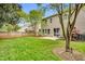 Spacious backyard with a well-maintained lawn, wooden fence, and a patio area for outdoor entertaining at 105 Ryder Cup Cir, Raleigh, NC 27603