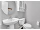 Small bathroom features a white sink and toilet in a neutral color palette at 105 Ryder Cup Cir, Raleigh, NC 27603