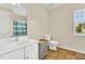 Bright bathroom featuring a white vanity with a sink and a toilet near a sunlit window at 105 Ryder Cup Cir, Raleigh, NC 27603