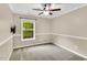 Cozy bedroom with a ceiling fan, fresh paint, and a window offering ample natural light at 105 Ryder Cup Cir, Raleigh, NC 27603