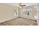 Neutral bedroom features a ceiling fan, window with shutters, and plush carpeting at 105 Ryder Cup Cir, Raleigh, NC 27603