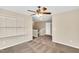 Spacious bedroom with a ceiling fan, carpeted floors and built-in shelving at 105 Ryder Cup Cir, Raleigh, NC 27603