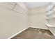 Walk-in closet features built-in shelving and carpeted floors for organized storage at 105 Ryder Cup Cir, Raleigh, NC 27603
