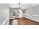 Neutral dining room with hardwood floors, chandelier lighting and natural light at 105 Ryder Cup Cir, Raleigh, NC 27603