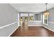 Spacious dining room featuring hardwood floors and an elegant chandelier light fixture at 105 Ryder Cup Cir, Raleigh, NC 27603