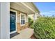 Inviting covered front porch featuring stone accents and a stylish dark blue door at 105 Ryder Cup Cir, Raleigh, NC 27603