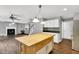 Kitchen features a center island that opens to the living room and fireplace at 105 Ryder Cup Cir, Raleigh, NC 27603