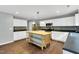Bright kitchen features stainless appliances, island, dark counter tops and tile back splash at 105 Ryder Cup Cir, Raleigh, NC 27603