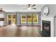 Bright living room features wood floors, fireplace, and sliding glass doors to the backyard at 105 Ryder Cup Cir, Raleigh, NC 27603
