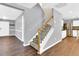 View of the home's staircase, with wood and white trim and leading to the upper level at 105 Ryder Cup Cir, Raleigh, NC 27603